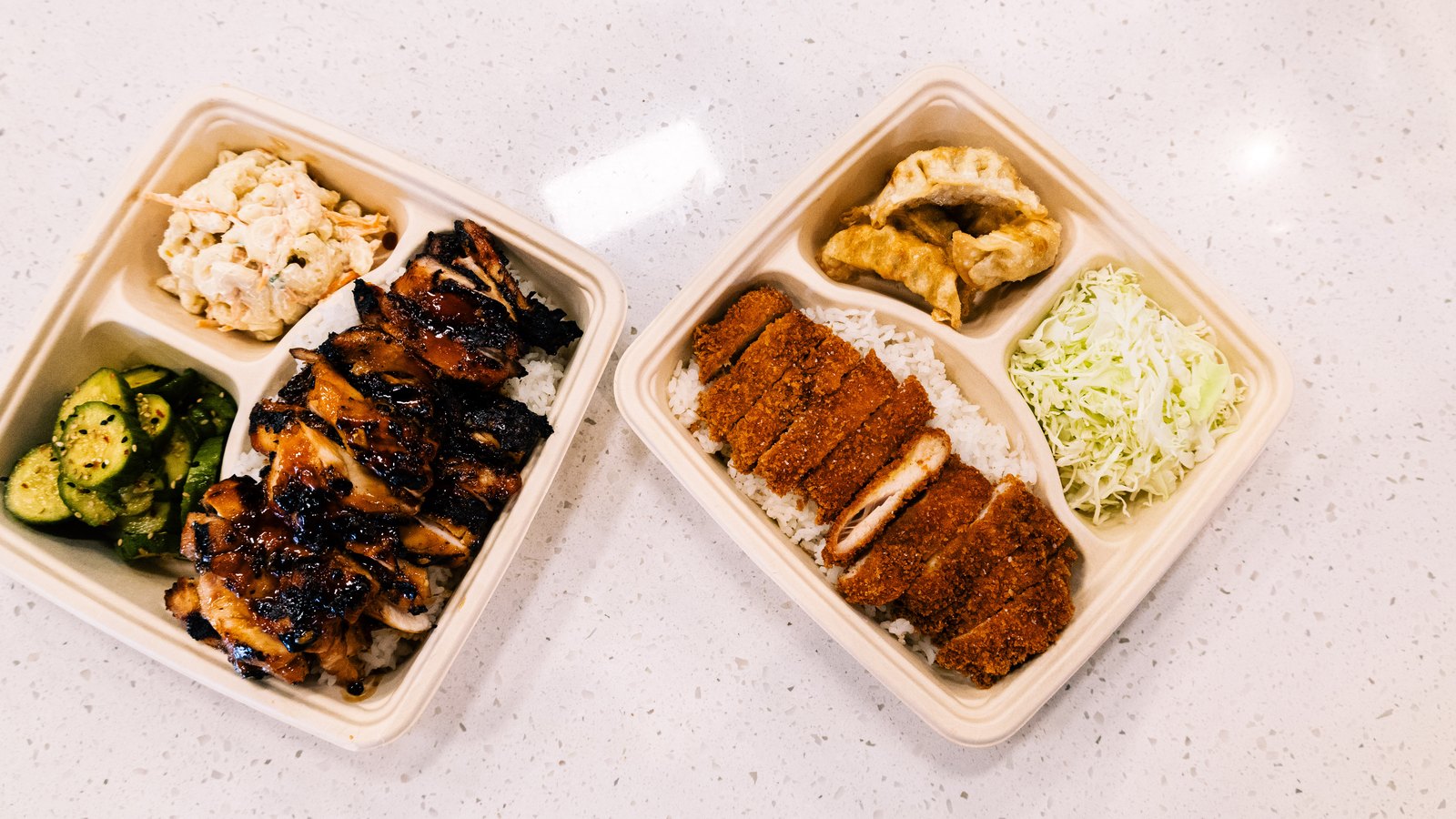 Grillbird teriyaki and katsu bento trays with gyoza and sides