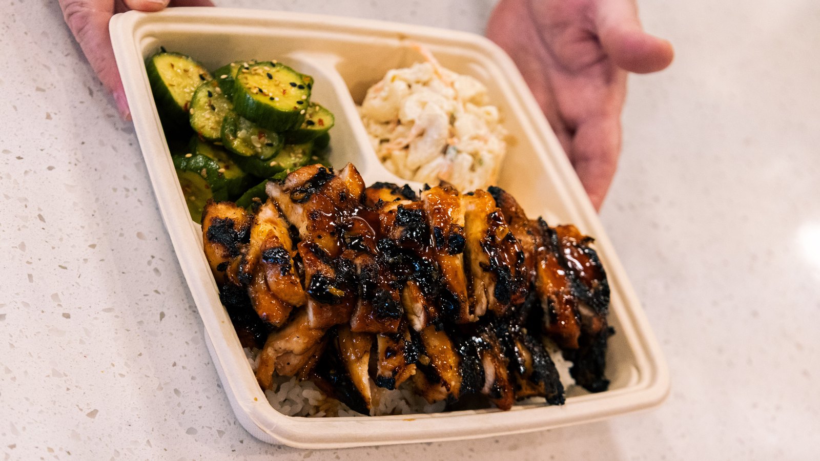 Grillbird teriyaki chicken bento with rice, cucumber salad, and mac salad